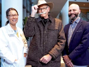 UC San Diego Health oncologists Rebekah White, MD and Gregory Botta, MD, PhD standing with patient Danny Boitano.